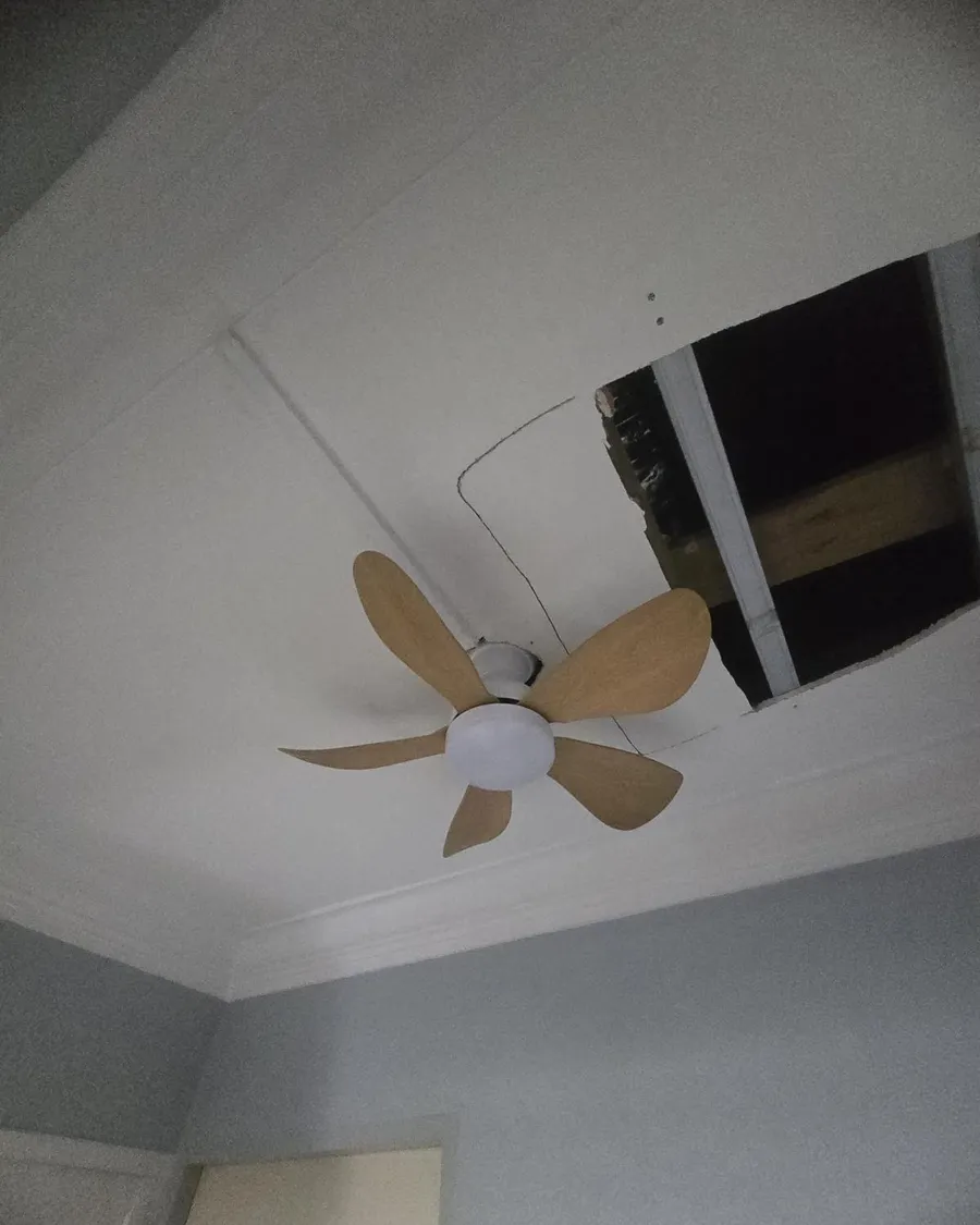 Five-blade wooden ceiling fan installed below a false ceiling in an HDB flat in Singapore