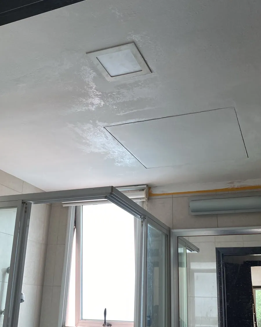 Repainted toilet ceiling with the service access panel refitted in a Singapore flat